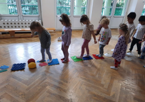 Maluchy przechodzą po torze sensorycznym.