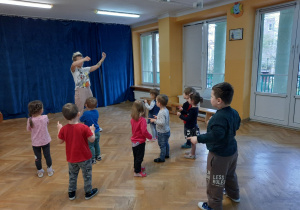 Dzieci wspólnie z trenerką zumby uczą się ruchów do nowego układu tanecznego.